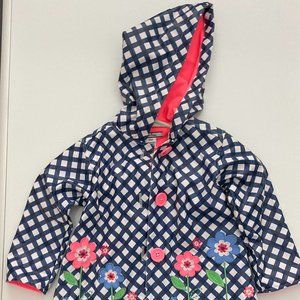 Hartstrings girls raincoat, blue and white with flowers and a green hem, size 18